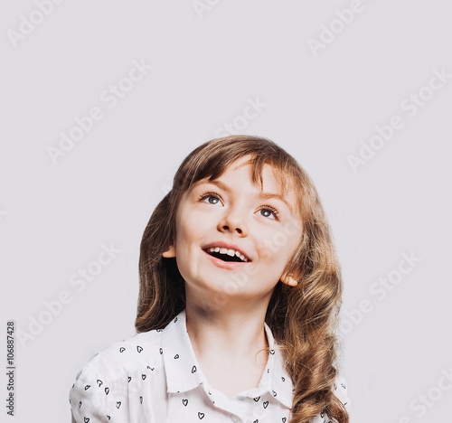 Beautiful little girl isolated on gray background