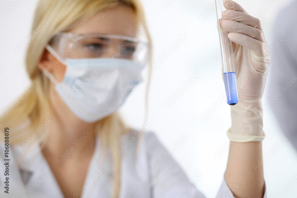 Scientific research team with clear solution in laboratory Scientific research team with clear solution in laboratory