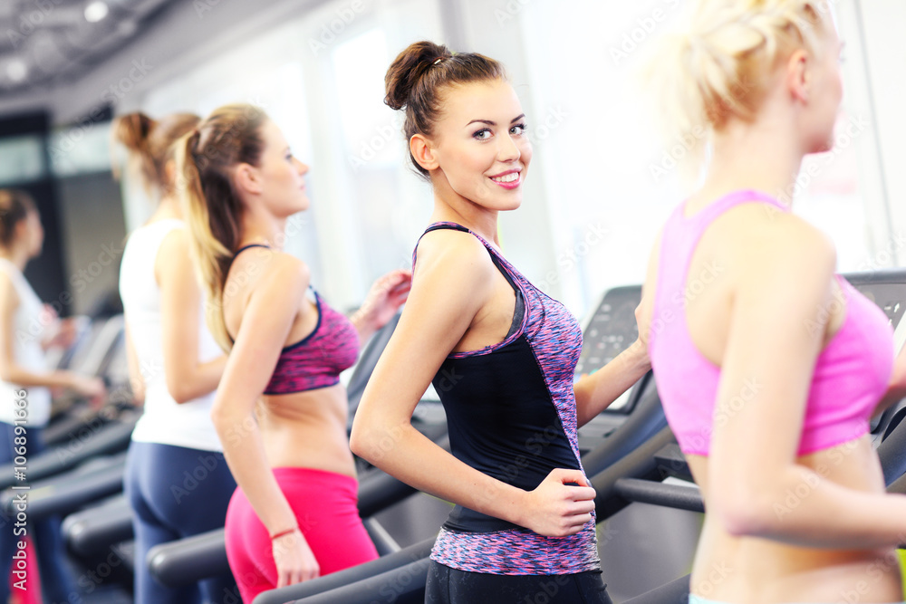 Group of women jogging on treadmill