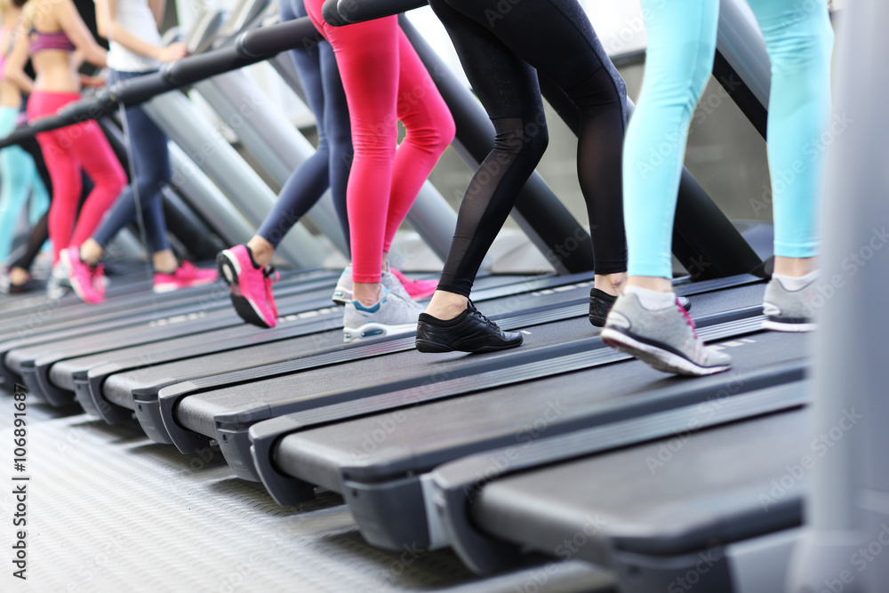 Group of women jogging on treadmill Group of women jogging on treadmill