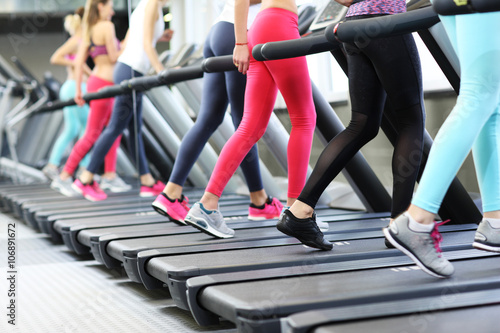 Group of women jogging on treadmill