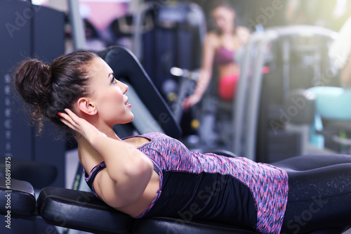 Woman doing sit ups in gym