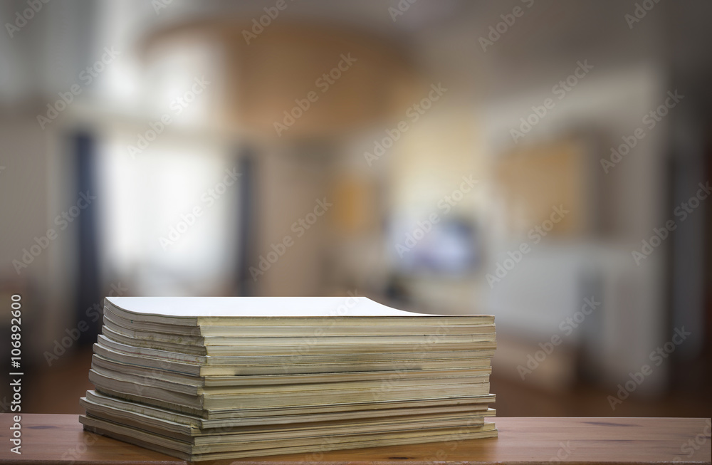 stack of old magazines on wooden table stack of old magazines on wooden table
