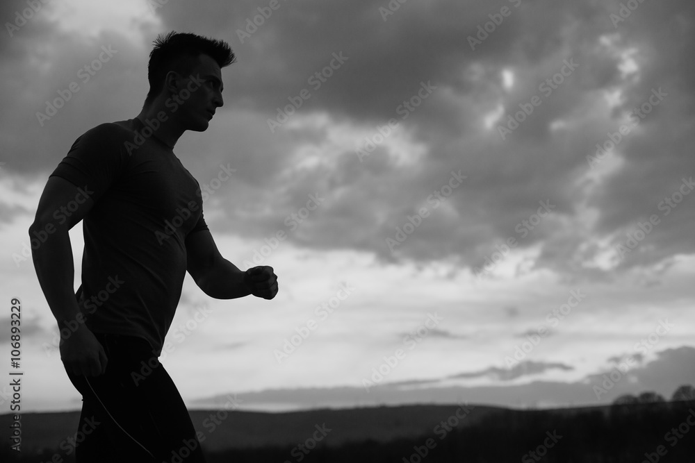 healthy man jogging in the city at early morning in night