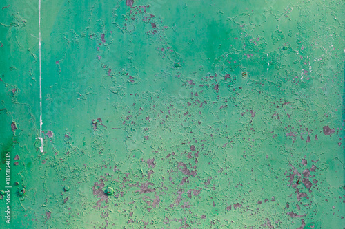 Old green cracked paint on metal background