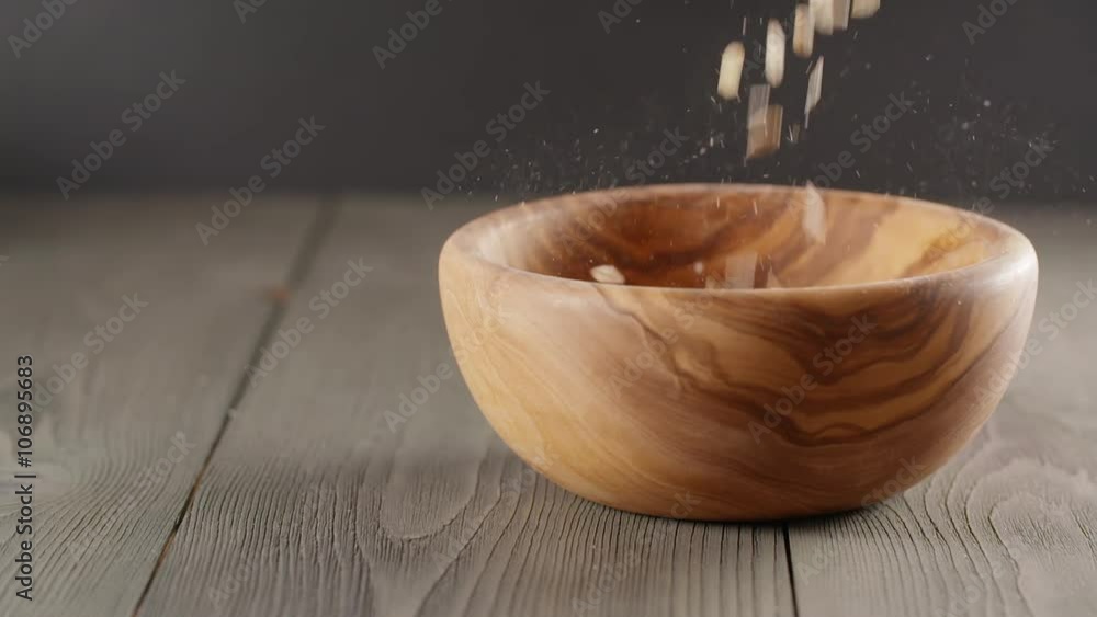 oat flakes falling into wood olive bowl closeup slow motion footage, prores footage oat flakes falling into wood olive bowl closeup slow motion footage, prores footage