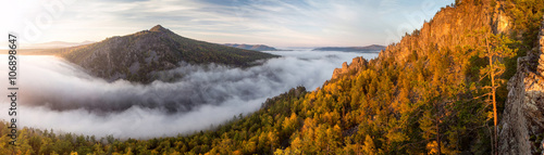 Great view of the foggy valley with sunrise. South Ural mountain