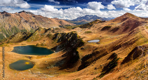 Panoramic view over the lakes and mountains in early autumn in A © EdNurg