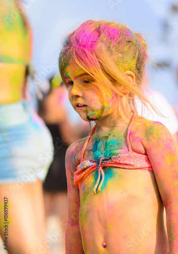 Cute young little girl smiling with colorful body