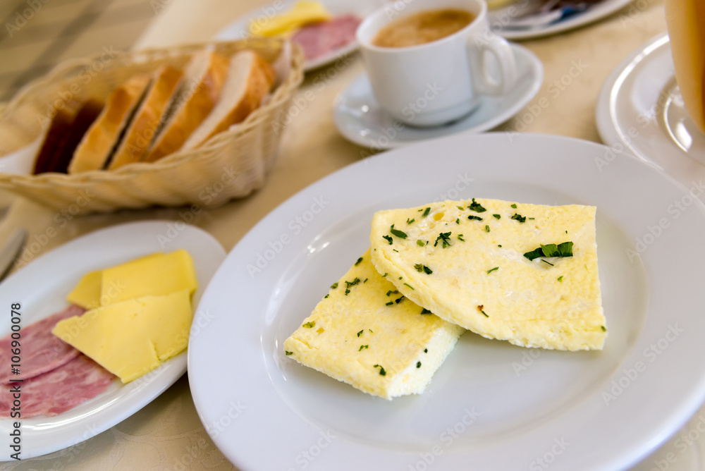 Breakfast with omelet and coffee on table in cafe Breakfast with omelet and coffee on table in cafe