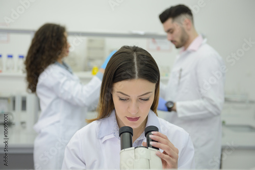 Woman working with a microscope