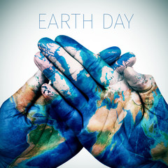 text earth day and man hands patterned with a world map (furnish