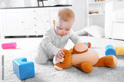 Cute baby boy playing with ...