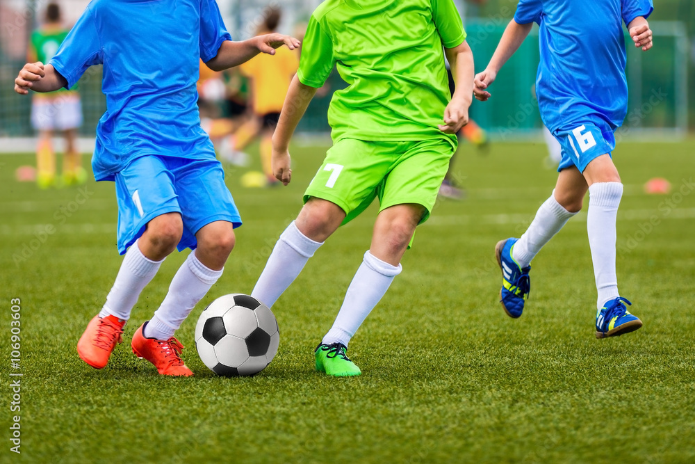 Young boys playing youth soccer football game Young boys playing youth soccer football game