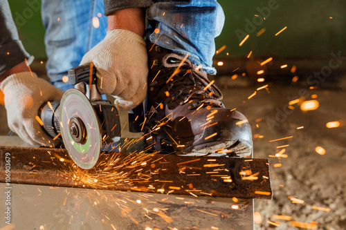 Worker working of a grinding machine photo