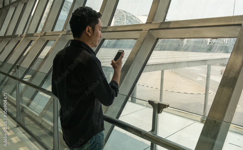 Man use smart phone in airport Man use smart phone in airport