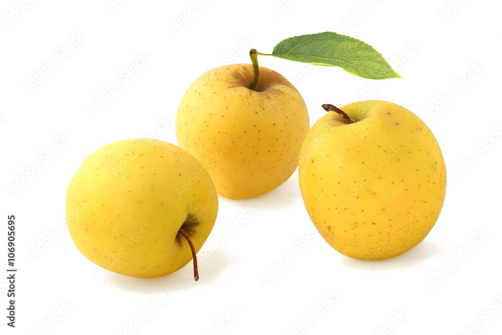 Three yellow apples with leav isolated on white