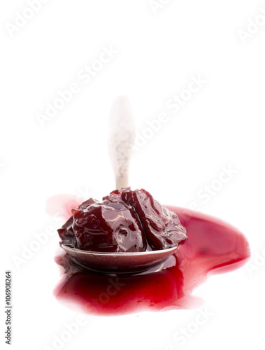 Cherry, cherry jam on a spoon. isolated white background.