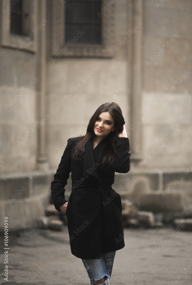 Beautiful brunette young woman posing on the street in old city