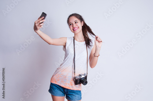 Pretty photographer girl taking selfie and smiling at camera