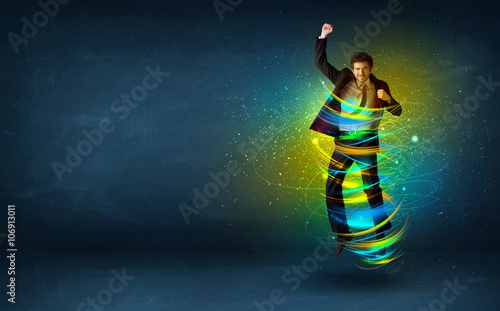 Excited business man jumping with energy colourful lines