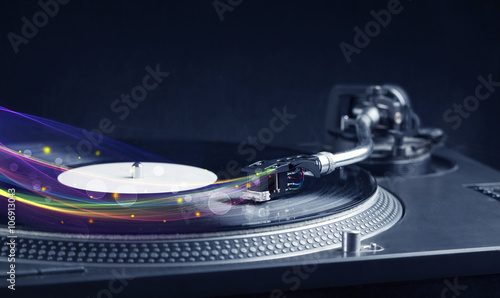 Turntable playing vinyl with glowing abstract lines