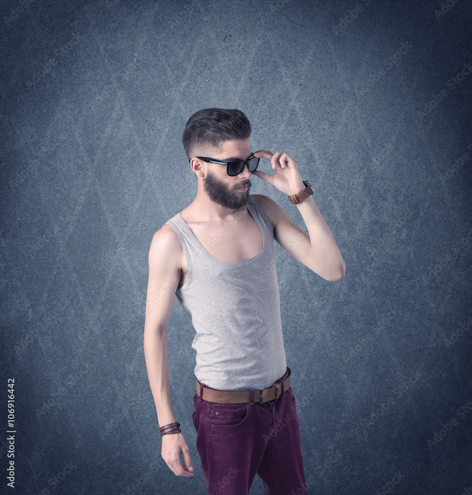 Bearded hipster standing in elegant clothes Bearded hipster standing in elegant clothes