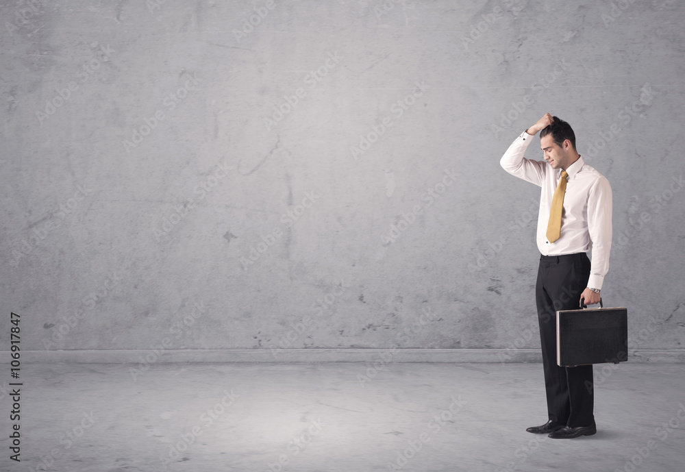 Young businessman standing confused Young businessman standing confused