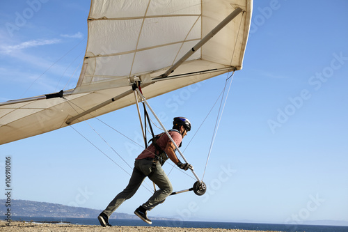 Hang glider pilot taking off