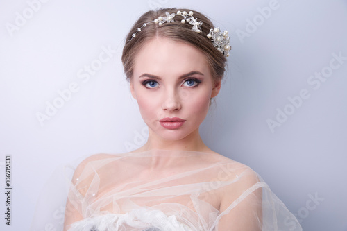 beautiful woman  bride with tiara on head  on bright background , copy space.
