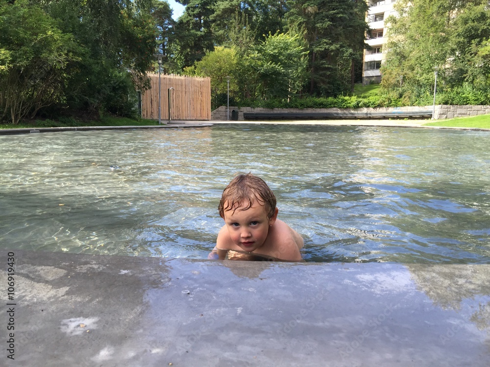 Fototapeta premium Lonely boy in pool, summer time. 