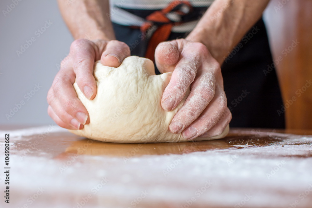 Baker makes bread on the table