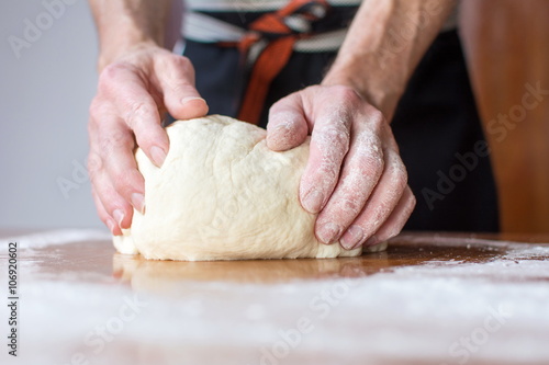 Baker makes bread on the table
