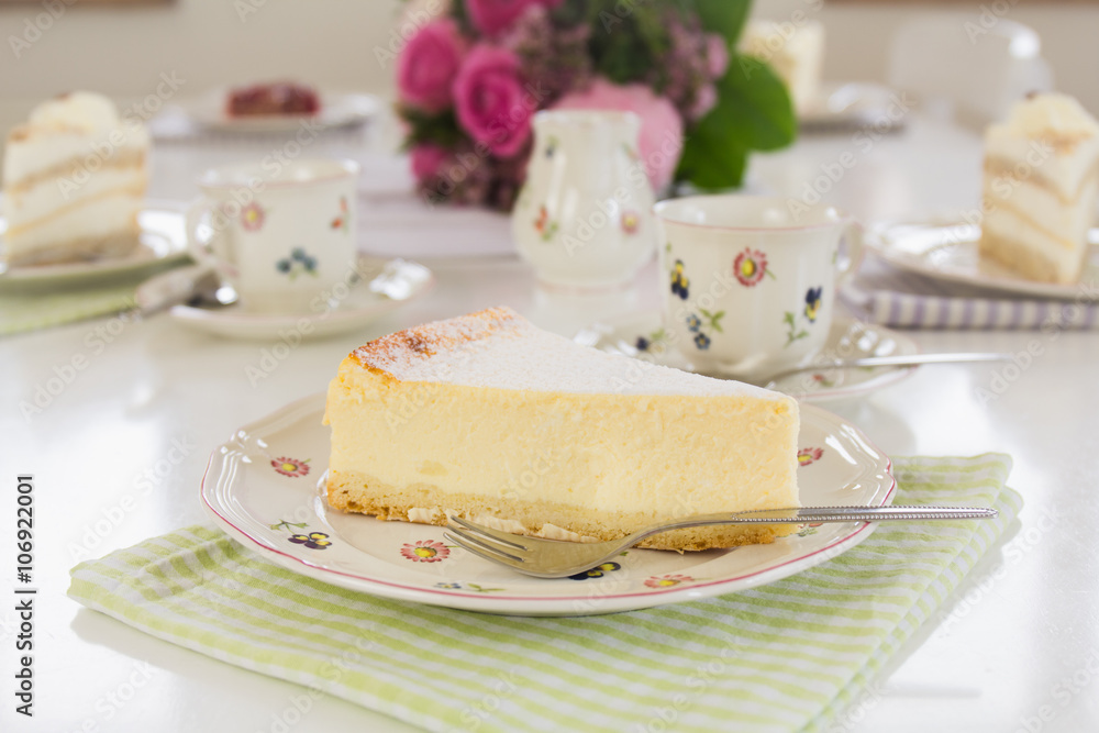 A piece of cheesecake on a flowered plate is on the table. Guests can come, Happy Birthday! A piece of cheesecake on a flowered plate is on the table. Guests can come, Happy Birthday!
