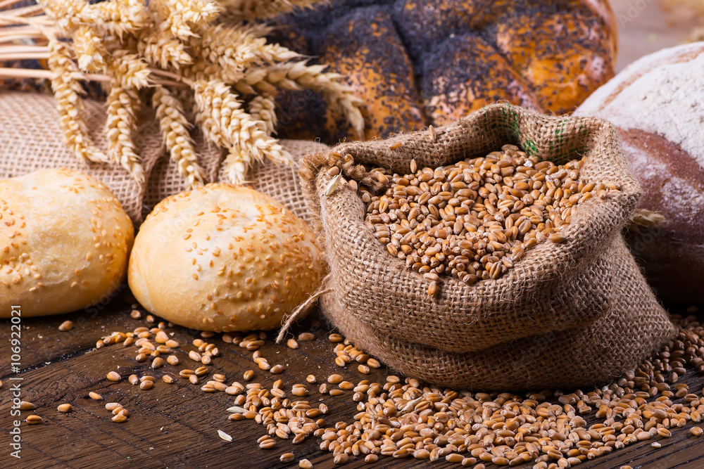 Assortment of baked bread on wooden table background Assortment of baked bread on wooden table background