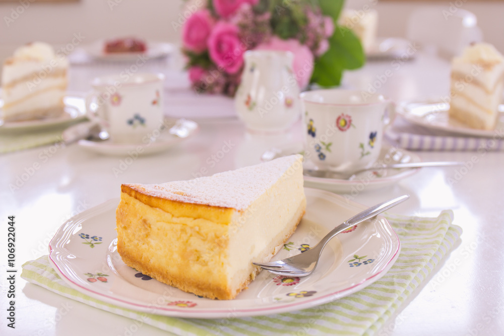 A piece of cheesecake on a flowered plate is on the table. Guests can come, Happy Birthday! A piece of cheesecake on a flowered plate is on the table. Guests can come, Happy Birthday!