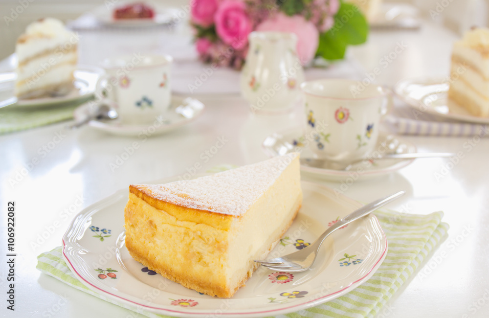 A piece of cheesecake on a flowered plate is on the table. Guests can come, Happy Birthday! A piece of cheesecake on a flowered plate is on the table. Guests can come, Happy Birthday!