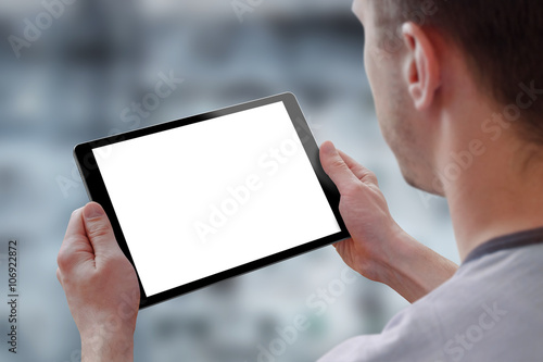 Tablet with isolated screen for mockup in man hands. City life in background. Isolated device screen for design, interface promotion.