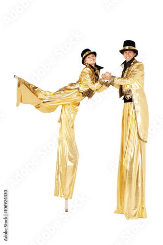 Boy and girl on stilts