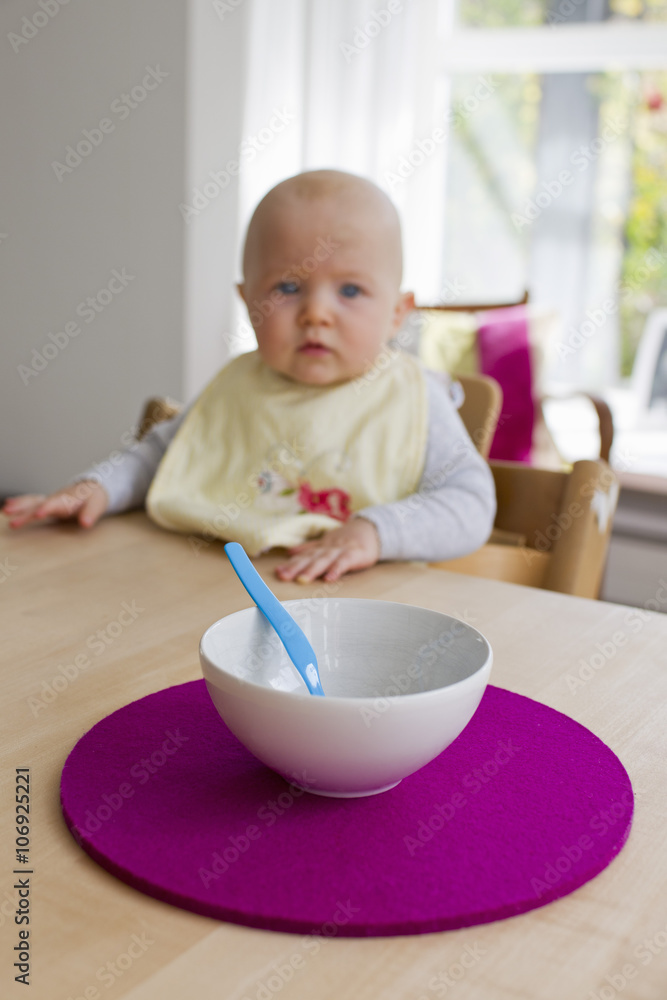 Baby girl staring at empty bowl and spoon Baby girl staring at empty bowl and spoon