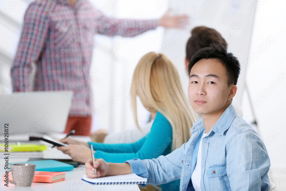 Young Asian man sitting at the office meeting