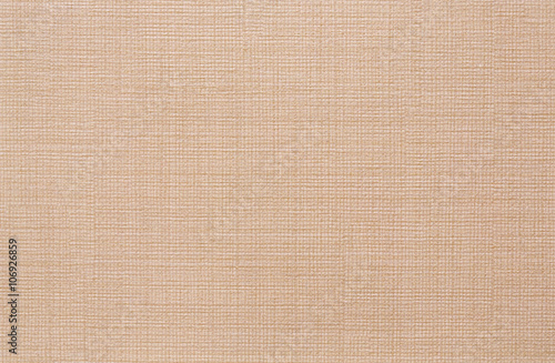 Beige coloured embossed surface. Closeup