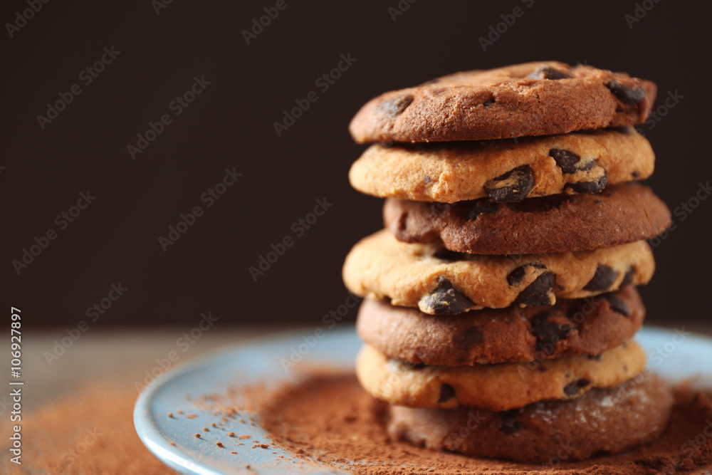 Chocolate chip cookies on plate on wooden table