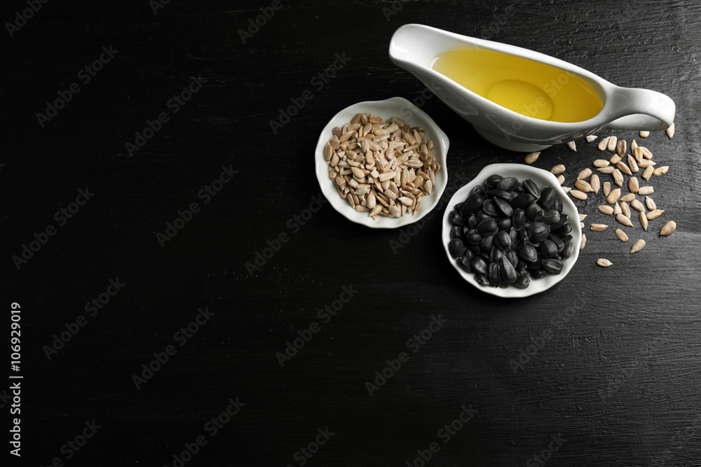 Sunflower seeds with oil on wooden table Sunflower seeds with oil on wooden table