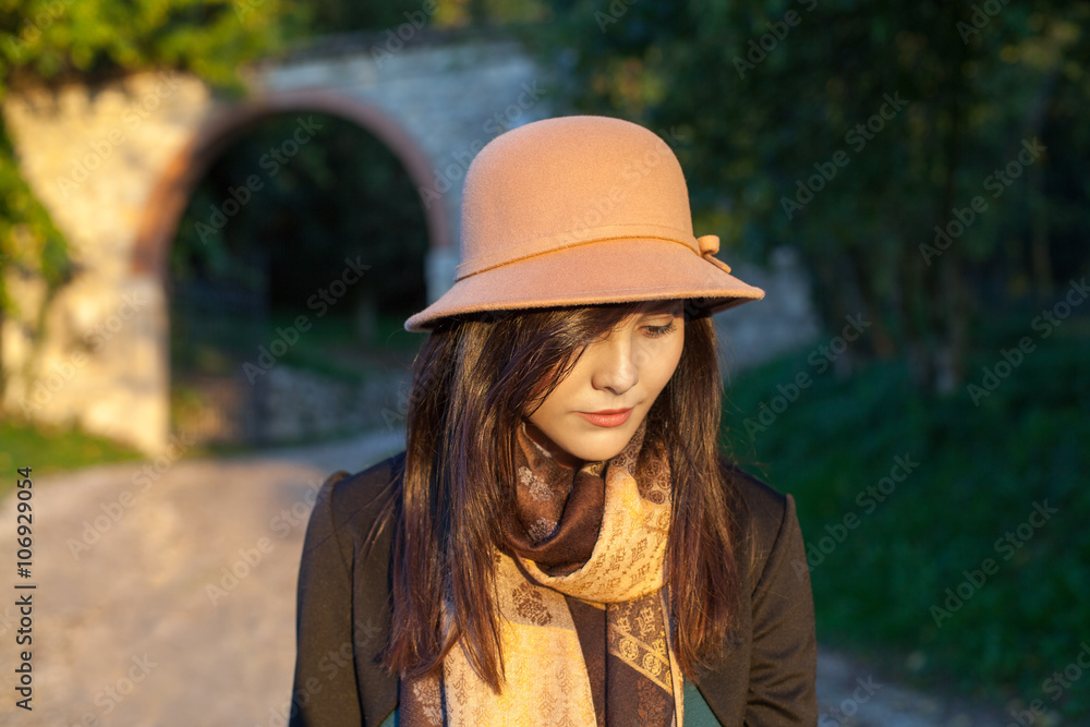 Spring and autumn portrait of cute young woman with hat