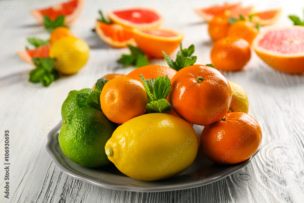 Set of different citrus fruit on light wooden table Set of different citrus fruit on light wooden table