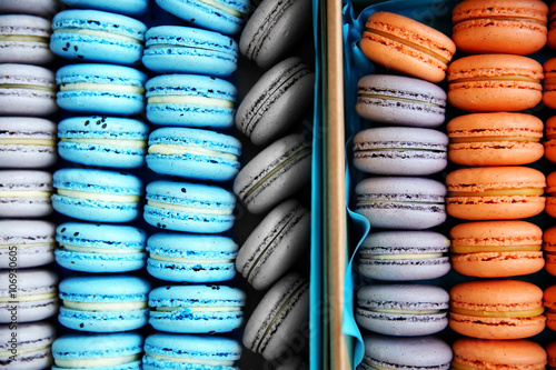 Varicolored tasty macaroons in boxes, close up