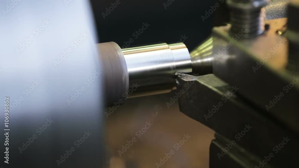 Turning lathe in action.Facing operation of a metal blank on turning machine with cutting tool.Old turning lathe machine in turning workshop.Operator machining high precision mold part by cnc lathe Turning lathe in action.Facing operation of a metal blank on turning machine with cutting tool.Old turning lathe machine in turning workshop.Operator machining high precision mold part by cnc lathe