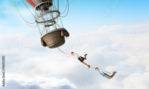 Business people fly on balloon photo