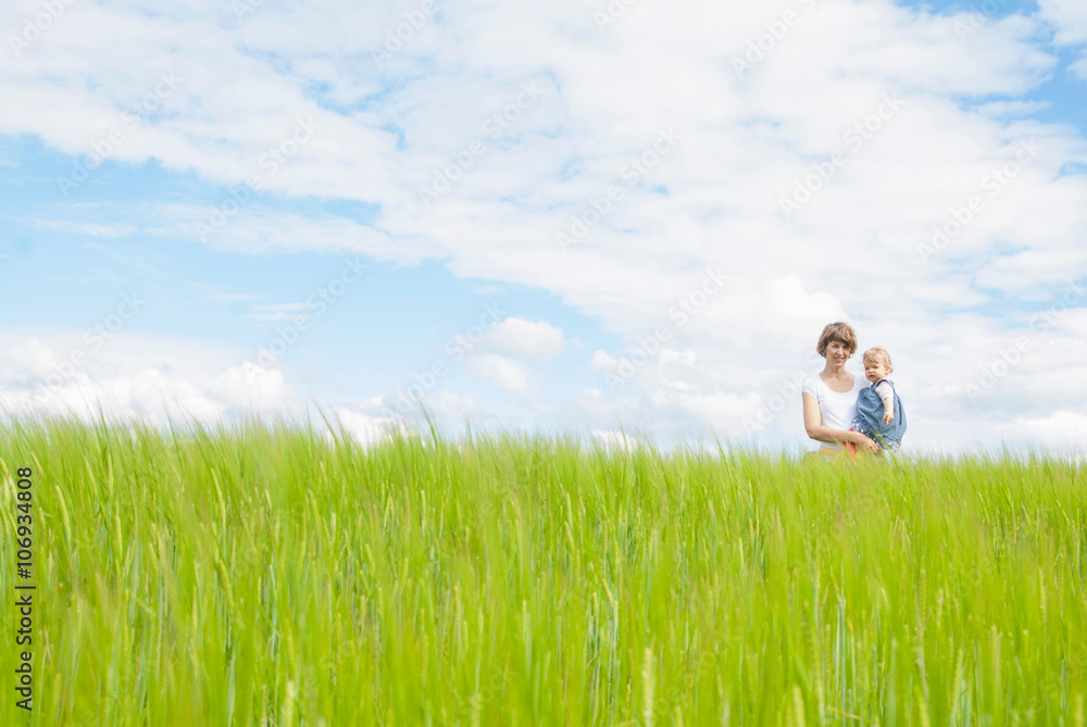 Mother holding daughter in field